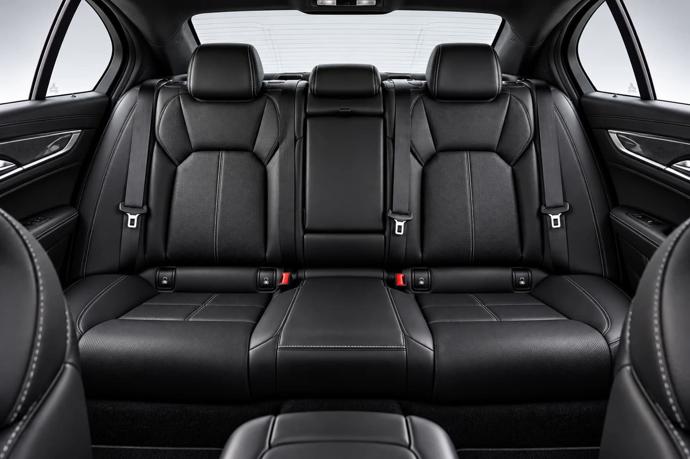 Cadillac CT5 rear black leather seats with headrests and seatbelts.